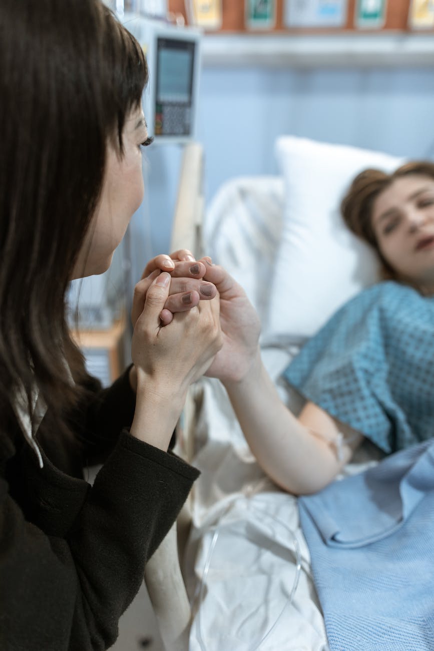 a woman holding a patient s hand