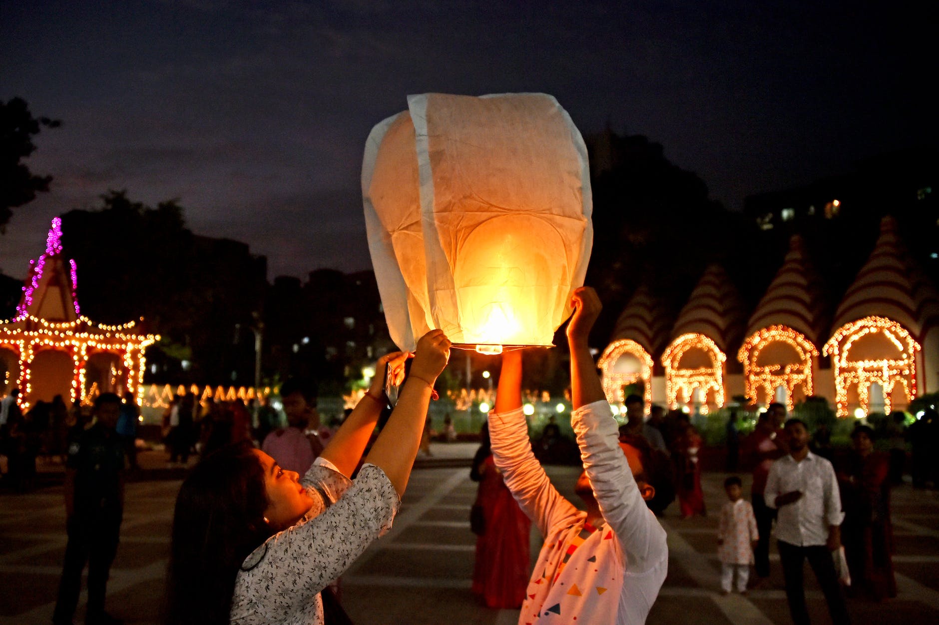 couple releasing flaming paper lantern